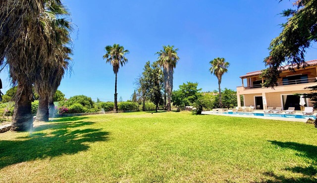 Palm Villa Ammes | Luxury Estate Pool Tennis Court Steps from Ammes Beach